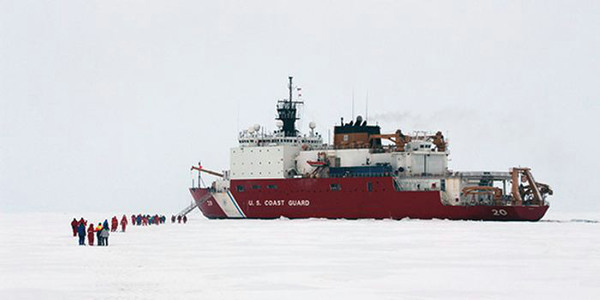 Icebreaker and people walking on the ice.