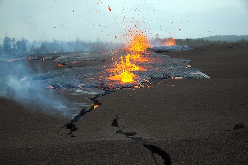 Vulkanisk aktivitet, eld och lava sprutar upp ur sprickor i berget. Lava nådde ytan längs en aktivt spricka under Kīlauea-vulkanens Kamoamoa-utbrott den 5 mars 2011 på Hawaiiöarna.